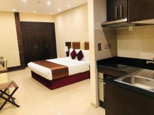 a hotel room with a bed and a kitchen at The View Al Barsha Hotel Apartments in Dubai