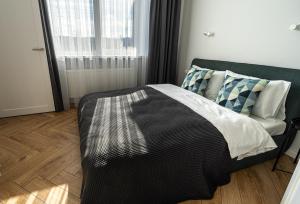 a bedroom with a bed and a window at Wonderful Apartment In The Heart Of Kaunas Center in Kaunas