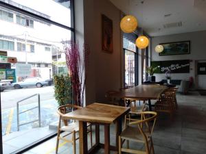 a restaurant with two tables and chairs and a window at MD Boutique Hotel in Kampar