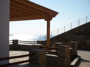 a stairway with a wooden roof and a fence at Monolithos Villas in Kipri