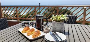 a table with two plates of croissants and a blender at Sea Stay Umdloti Beach in Umdloti