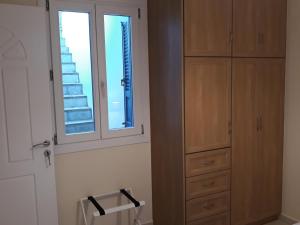 a bedroom with a dresser and a window at Monolithos Villas in Kipri