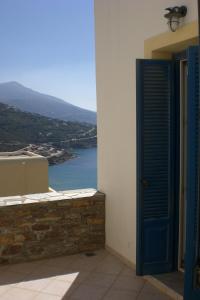a door to a balcony with a view of the water at Monolithos Villas in Kipri