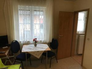 a table and chairs in a room with a window at Jurahof Wuermser in Denkendorf