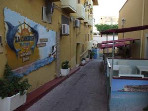 an empty alley in a city with a building at La Casa di Anna in Lampedusa