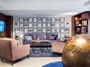 a living room with a couch and a table at Hotel Logos Kraków in Krakow