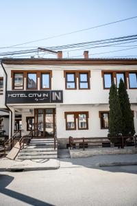 a building with a hotel entry into it at Hotel City IN in Kočani