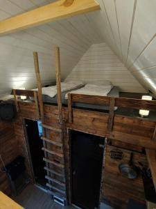 a room with two bunk beds in a tent at Brīvdienu namiņš ar pirtiņu in Kuyvizhi