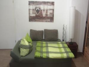 a couch with two pillows in a living room at Ferienwohnung Apfelbaum in Schonungen
