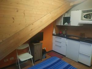 a kitchen with a wooden staircase in a room at Mansarda Arel in Turin