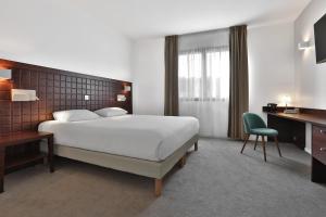 Llit o llits en una habitació de KYRIAD Périgueux - Boulazac