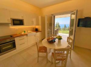 a kitchen and dining room with a table and chairs at Paleopetres K-Five - Premium Double Suite - Kalami - in Kalami