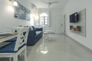 a living room with a couch and a table at Puerto Mogan Apartment in Puerto de Mogán
