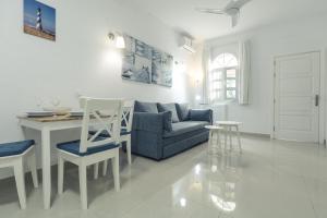 a living room with a couch and a table at Puerto Mogan Apartment in Puerto de Mogán