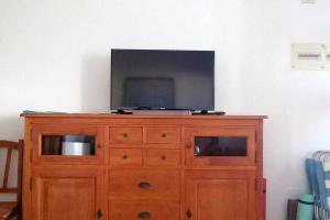 a wooden dresser with a television on top of it at Famara Sweet Home in Famara