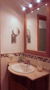 a bathroom with a sink and a mirror at Famara Sweet Home in Famara