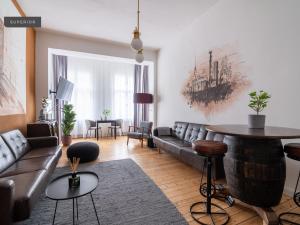 a living room with a couch and a table at Apartments Berlin Bornimer Straße in Berlin