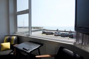a room with a window with a view of the beach at Westpoint Apartments in West Bay