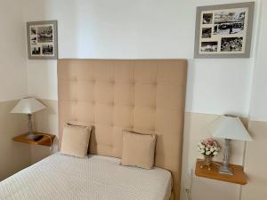 a bedroom with a bed and two lamps on tables at Duarte Houses - Casa T1 - com vista mar in Nazaré