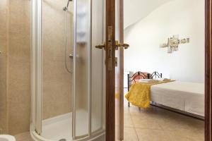 a bathroom with a shower and a bed at Villa Martina by BarbarHouse in Carovigno +42 photos