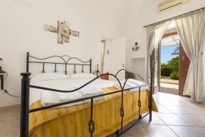 a bedroom with a bed and a balcony at Villa Martina by BarbarHouse in Carovigno