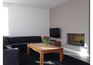 a living room with a couch and a coffee table at Vakantiewoning Yerseke in Yerseke