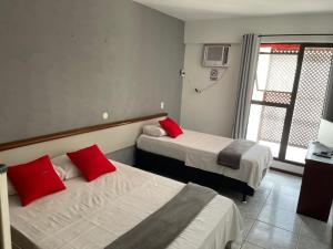 Ein Bett oder Betten in einem Zimmer der Unterkunft Rasa Hotel