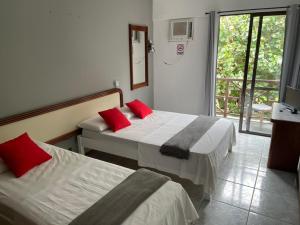 Ein Bett oder Betten in einem Zimmer der Unterkunft Rasa Hotel