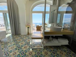 a bathroom with a sink and a mirror at Hotel Montemare in Positano