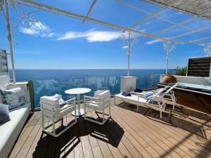 a deck with a table and chairs on a yacht at Hotel Montemare in Positano