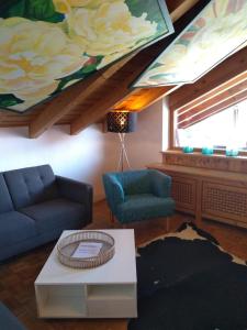 ein Wohnzimmer mit einem Sofa und einem Gemälde an der Wand in der Unterkunft Ferienwohnung Alpensonne in Oberstdorf