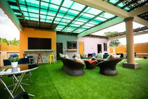 a living room with a patio with green grass at Brynx Haven - Cape Coast in Cape Coast