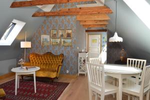 a living room with a couch and a table at Hotell St Clemens in Visby