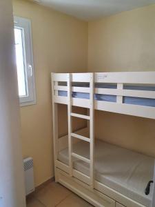 two bunk beds in a room with a window at Appartement Les Restanques du Golfe de Saint-Tropez in Grimaud