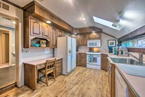 a kitchen with wooden cabinets and a white refrigerator at Runningwater Apartment in Lancaster with Deck in Lancaster