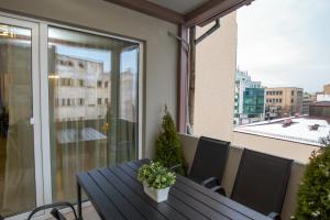 a balcony with a table with a plant on it at Metropole Apartments Old Center in Bucharest