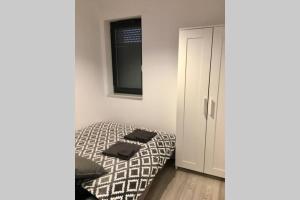 a bedroom with a bed with two towels on it at Apartament Fibra Bounty in Rybnik