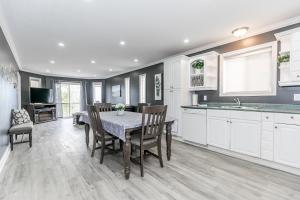 a kitchen and dining room with a table and chairs at Beach1 Riverfront Resort in Wasaga Beach