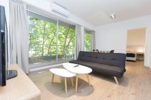 a living room with a black couch and a table at Babel Belgrano in Buenos Aires