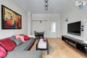 a living room with a couch and a flat screen tv at MS Apartments Centrum Gdyni I in Gdynia