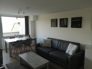 a living room with a couch and a table at Terrasses de Malmedy 453 in Malmedy