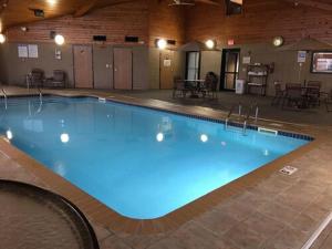 a large blue swimming pool in a building at AmericInn by Wyndham Sioux City in Sioux City