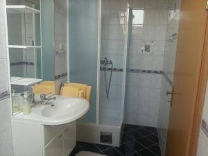 a bathroom with a sink and a shower at Guesthouse Magdalena in Rakovica