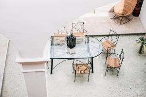 an overhead view of a glass table and chairs at Hotel Tabáa Oaxaca in Oaxaca City