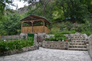 a small building with stairs and a wooden structure at Bjnihouse, guest house in Bjni