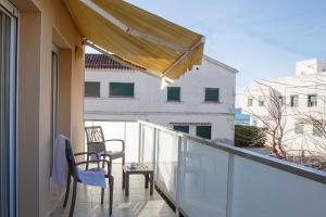 a balcony with two chairs and a table on it at Apartamentos La Torreta in Altafulla