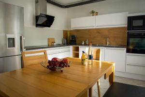 a kitchen with a wooden table with a bowl of fruit on it at Ferienwohnung Donau in Balingen