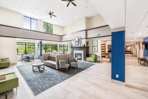 a living room with a couch and a fireplace at Holiday Inn Express - Delafield, an IHG Hotel in Delafield