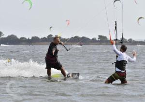 two men are playing in the water on the water at Kite Hub Lo Stagnone in Birgi Vecchi