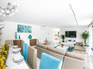 a living room with a couch and a table and chairs at Luxury Villa Aleana in Portimão